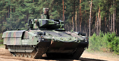 PUMA IFV drives on ground at edge of forest