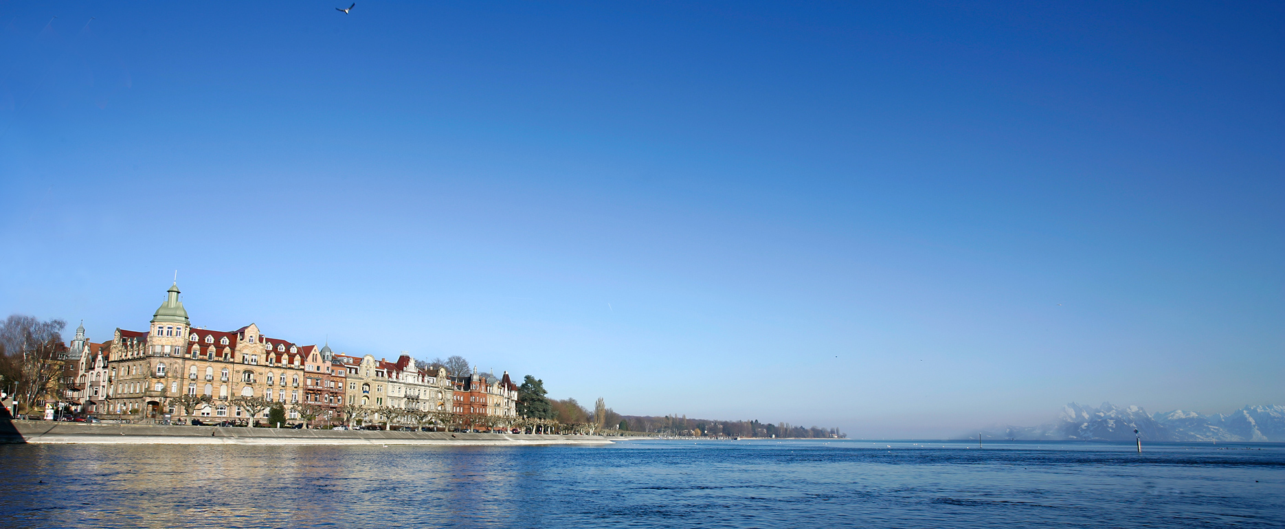 Lake Constance at the Old Rhine Bridge in Konstanz with a view of houses on Seestraße