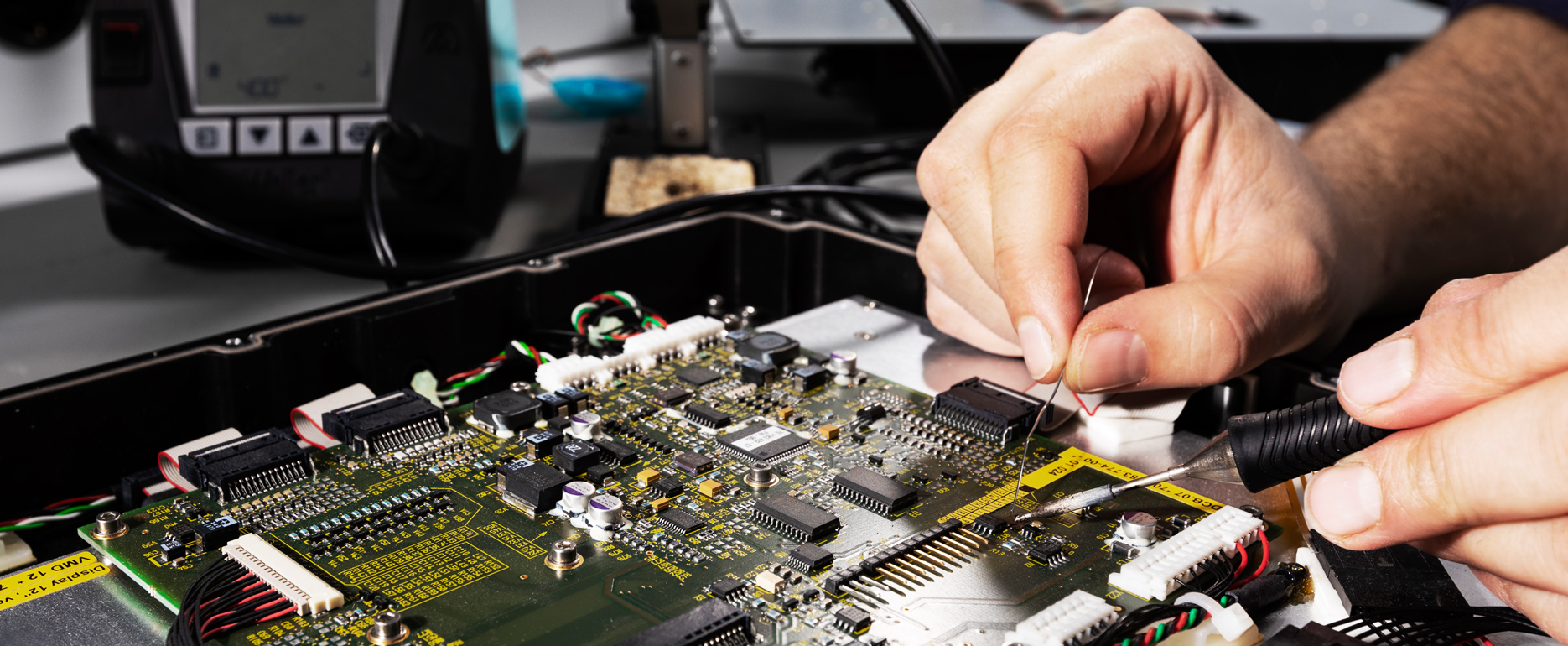 Hardware developer checking the circuit board of an open computer